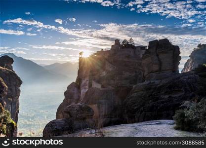 Scenic sunset evening sky over holy Varlaam monastery on cliff in Meteora, Thessaly Greece. Greek destinations. Sunset over Varlaam monastery in Meteora, Greece