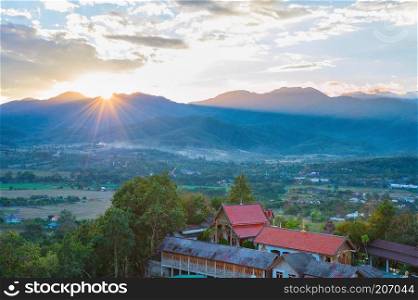 Scenic sunset landscape with Pai village in mountains valley, Thailand