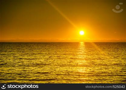 Scenic sunset or sunrise over sea surface. Natural scenery, beautiful landscape. Sunset or sunrise over sea surface