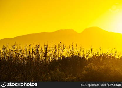 Scenic sunset or sunrise sun rising over mountain hill. Sunrise over mountain hill