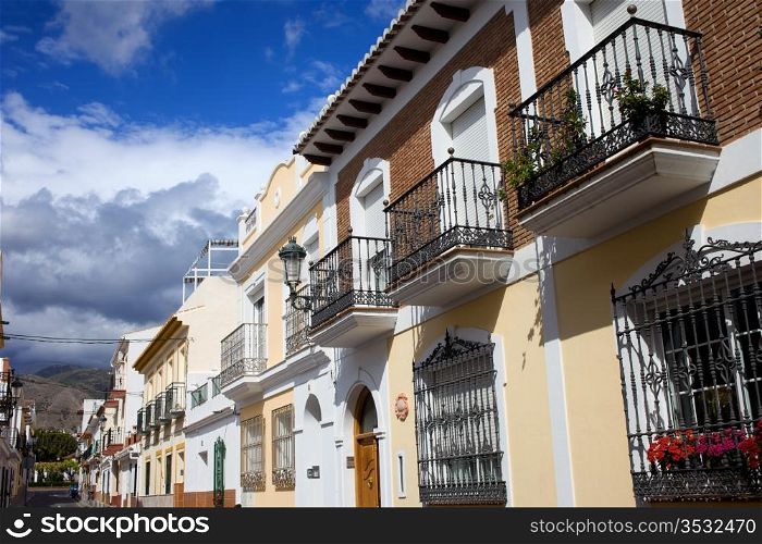 Scenic traditional apartment houses residential architecture on cosy tranquil street in resort town of Nerja, Andalusia region, southern Spain