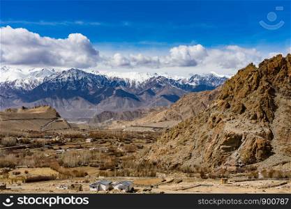 Scenic view between path on Khardung La, mountain pass in the Ladakh region of Jammu and Kashmir. The pass on the Ladakh Range lies north of Leh and is the gateway to the Shyok and Nubra valleys