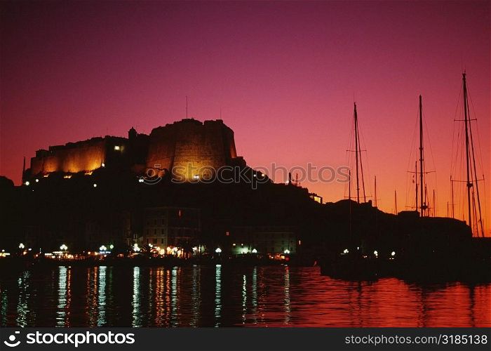 Scenic view of a fortress and a harbor at night, Bonifacio, Corsica, France