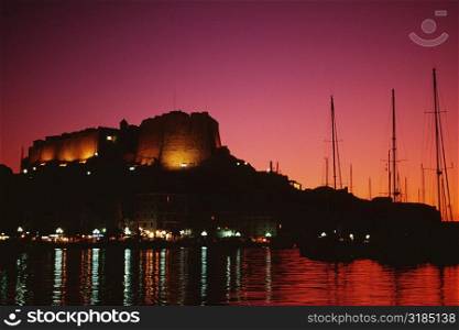 Scenic view of a fortress and a harbor at night, Bonifacio, Corsica, France