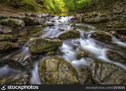Scenic view of amazing water motion blur of a water stream between rocks.