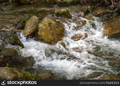 Scenic view of amazing water stream between rocks. Close up