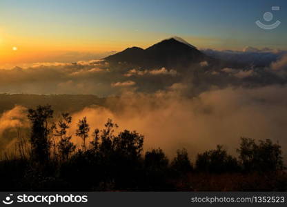 Scenic view of clouds and mist at sunrise from the top of mount Batur (Kintamani volcano), Bali, Indonesia