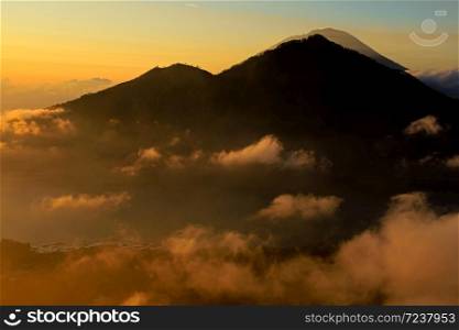 Scenic view of clouds and mist at sunrise from the top of mount Batur (Kintamani volcano), Bali, Indonesia