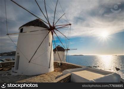 Scenic view of famous Mykonos town windmills. Traditional greek windmills on Mykonos island on sunset, Cyclades, Greece. Walking with steadycam.. Traditional greek windmills on Mykonos island at sunrise, Cyclades, Greece