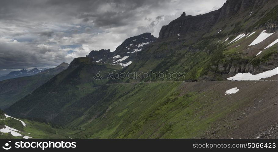 Scenic view of mountain range against cloudy sky, Going-to-the-Sun Road, Glacier National Park, Glacier County, Montana, USA