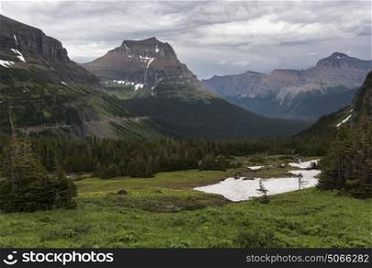 Scenic view of mountain range against cloudy sky, Logan Pass, Glacier National Park, Glacier County, Montana, USA
