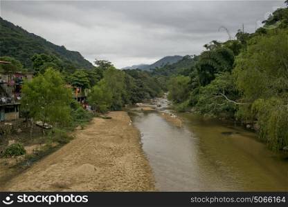 Scenic view of mountainside village by river, Yelapa, Jalisco, Mexico