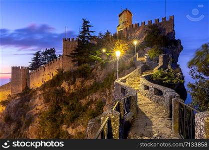 Scenic view of old medieval towers over the valley at sunset. San marino. San Marino. Old stone towers on top of the mountain.