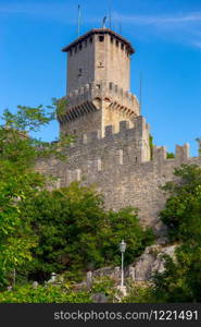 Scenic view of old medieval towers over the valley in the early morning. San Marino. Italy.. San Marino. Old stone towers on top of the mountain.