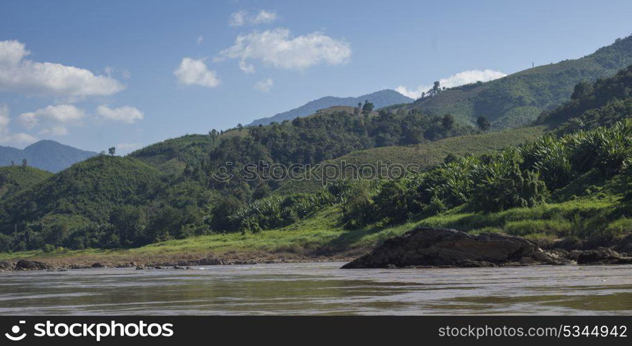 Scenic view of river shoreline with mountain range in background, River Mekong, Sainyabuli Province, Laos