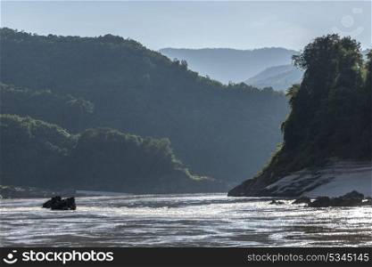 Scenic view of river with mountain range in background, River Mekong, Laos