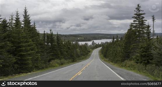 Scenic view of road by river against cloudy sky, Marine Drive, Nova Scotia, Canada