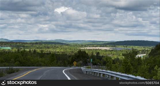 Scenic view of road passing through rural landscape, New Brunswick, Canada