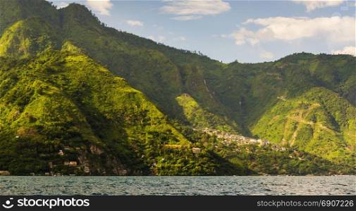 Scenic view of Santa Cruz nestled into mountains on Lake Atitlan, Guatemala, Central America