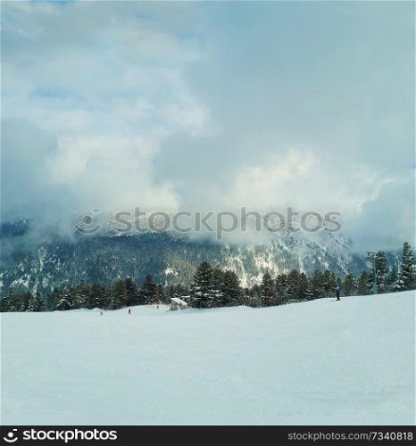 Scenic view of ski slope in Pirin mountains above the clouds.
