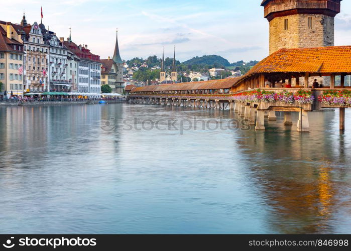 Scenic view of the Chapel, Kapellbrucke bridge, Wasserturm tower in the lantern light at sunrise. Lucerne. Switzerland.. Lucerne. The famous Chapel, Kapellbrucke bridge at dawn in night lighting.