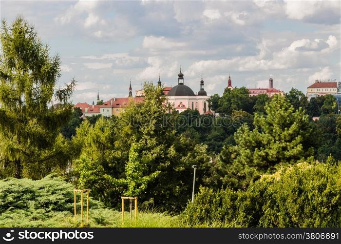 Scenic view of the historical center of Prague: houses, buildings, palaces, landmarks of old town with the characteristic and picturesque red rooftops and multi-coloured walls.
