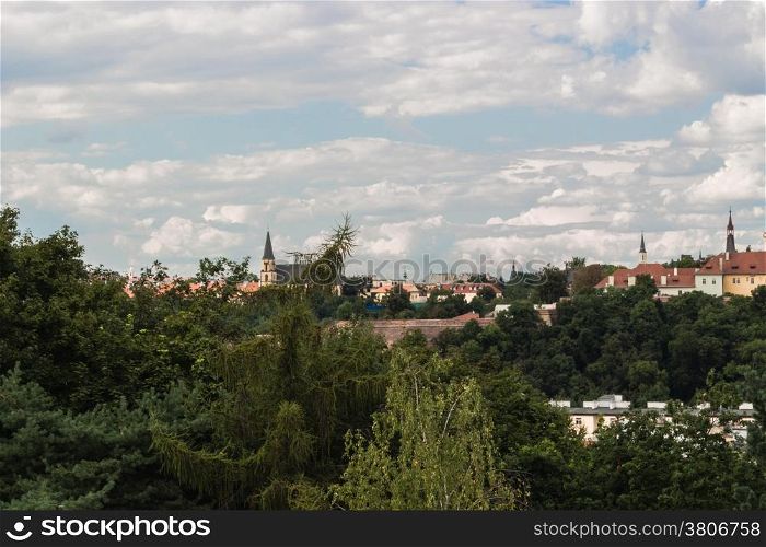Scenic view of the historical center of Prague: houses, buildings, palaces, landmarks of old town with the characteristic and picturesque red rooftops and multi-coloured walls.