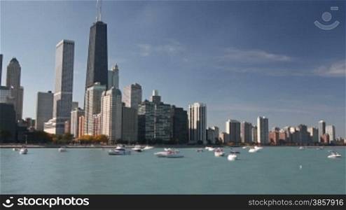 Scenic view of the Northern Chicago skyline from Navy Pier, with boats and Lake Michigan