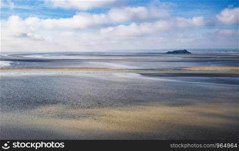 Scenic view on small Tombelaine tidal island from Le Mont Saint-Michel in Normandy