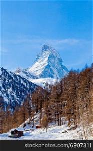 Scenic view on snowy Matterhorn peak in sunny day with blue sky. Switzerland