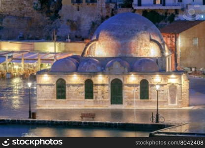 Scenic view Venetian embankment in Chania with the Mosque of Hassan Kuchuk Pasha at night. Crete, Greece.