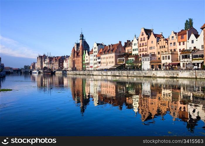 Scenic view with reflection on water of the Old Town of Gdansk in Poland by the Motlawa river