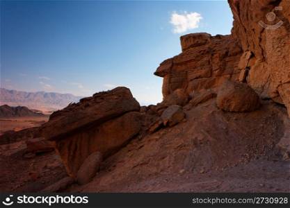 Scenic weathered orange rock in stone desert on sunset. Scenic weathered orange rock in stone desert on sunse
