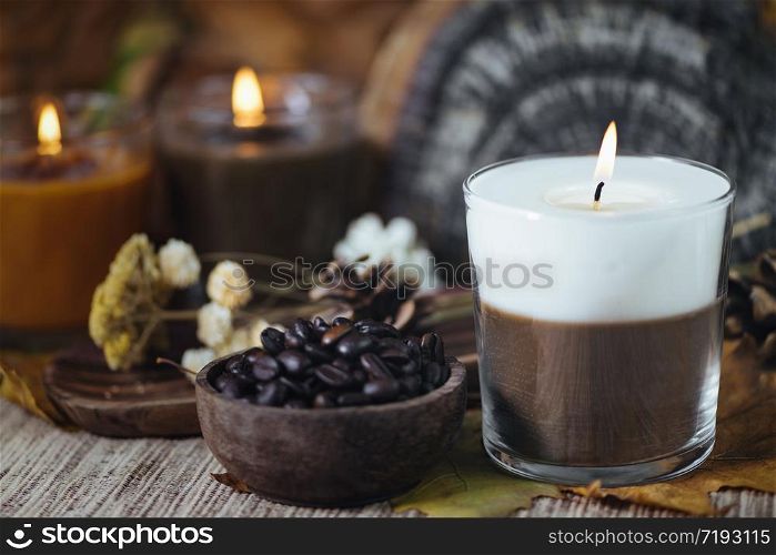 Scented coffee and vanilla dual color aromatic candle with coffee in wooden bowl. Scented Coffee and Vanilla Dual Color Aromatic Candle