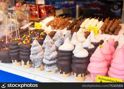 Schaumbecher traditional austrian sweets at christmas market. Krapfen waem sweet cake