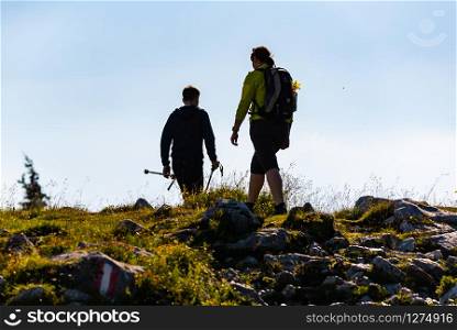 Schockl, Styria, Austria - 07.07.2018: A couple hiking over mountain in Austria Styria.Shockl a tourist and hiking destination.. A couple hiking over mountain in Austria Styria.