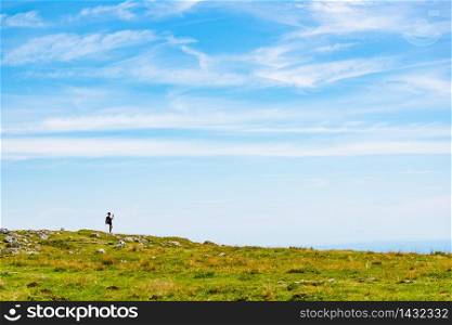 Schockl, Styria, Austria - 17.08.2019 : View from a peak of rocky Austrian mountain Schockl in Styria. Place for tourism and hiking recreation.. Woman with cellphone and backpack making photos of the view at schockl mountain in Graz