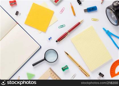 school accessories and open notebook or book with empty pages at white background, top view