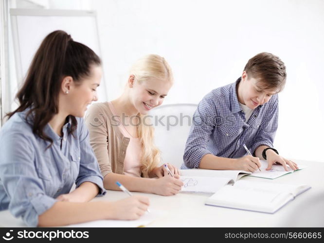 school and education concept - group of smiling students with notebooks at school