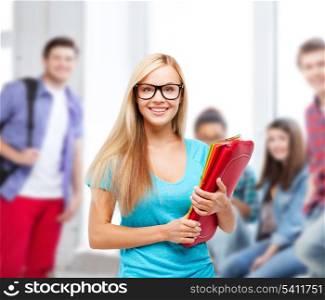 school and education concept - smiling student with folders