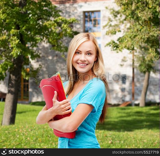 school and education concept - smiling student with folders