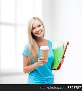 school and education concept - smiling student with folders and cup of coffee