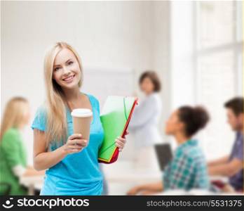 school and education concept - smiling student with folders and cup of coffee