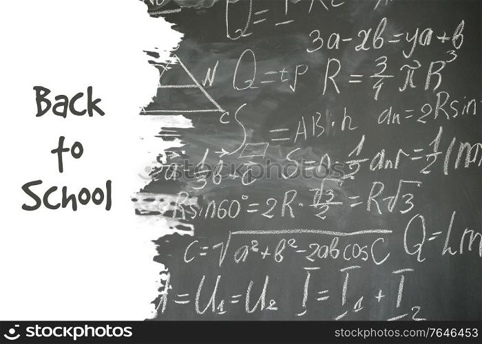 school background with math formulas written in white chalk on black board. math formulas on black board