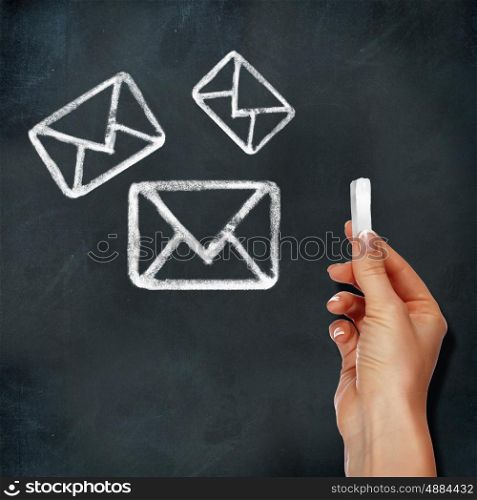 School blackboard and hand drawing mail symbol