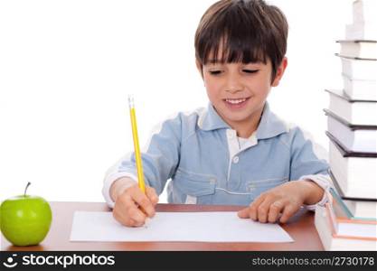 School boy doing his homework with an apple beside him on white background