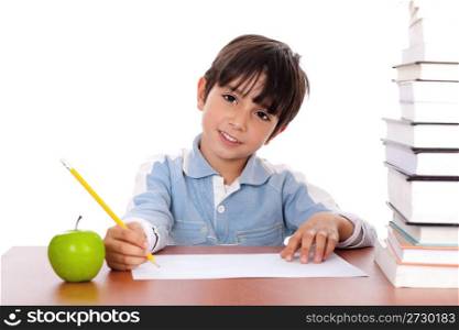 School boy doing his homework with an apple beside him on white background