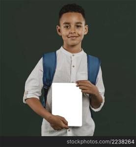 school boy holding copy space notebook
