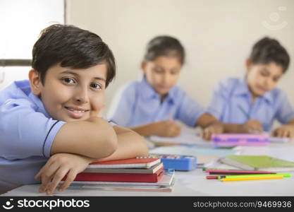 school boy sitting in class and smiling