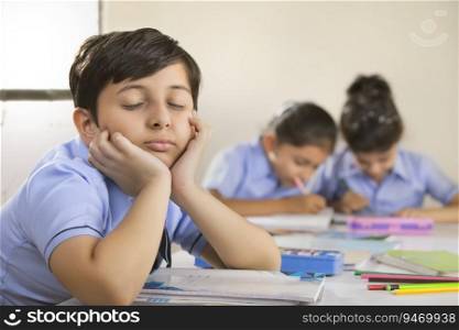 school boy sitting with eyes closed in class 